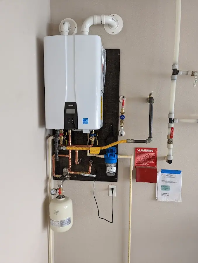 Professional plumber installing copper piping in a Conoy home